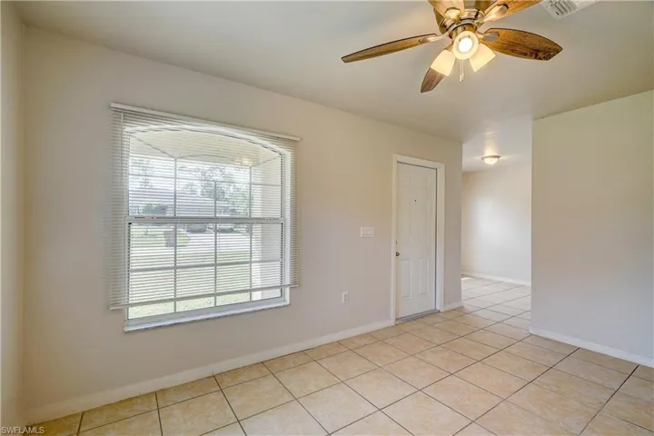 Spare room featuring ceiling fan and light tile patterned flooring