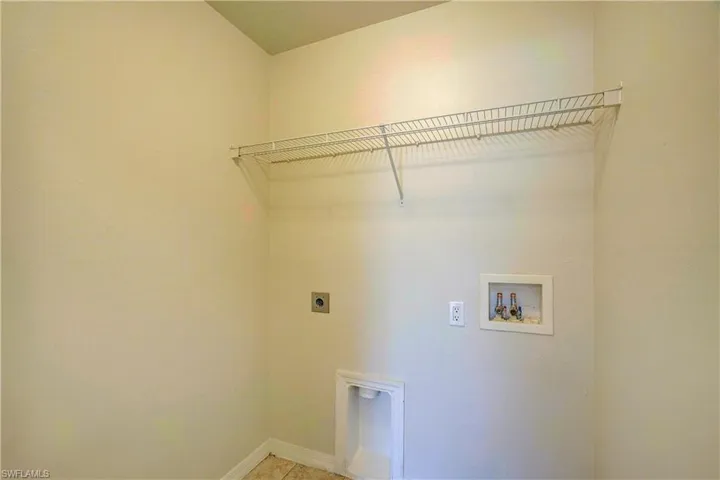 Clothes washing area featuring hookup for a washing machine and electric dryer hookup