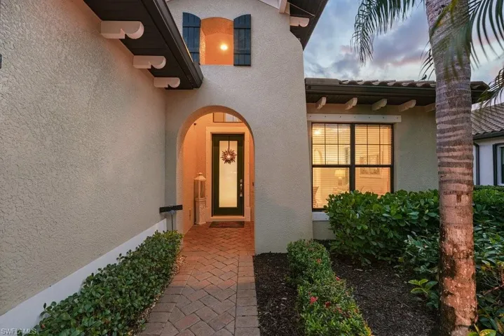 Stucco exterior with a tiled roof and decorative shutters
