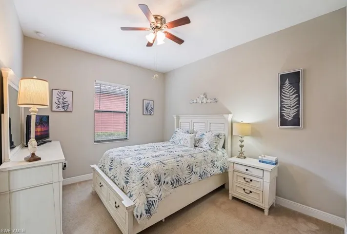 Vaulted ceiling with a ceiling fan, carpeted flooring, window with blinds, and white paneled bed frame