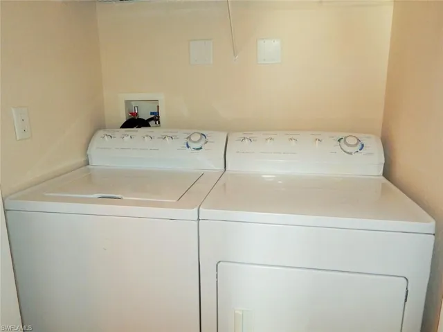 Washroom with washing machine and clothes dryer