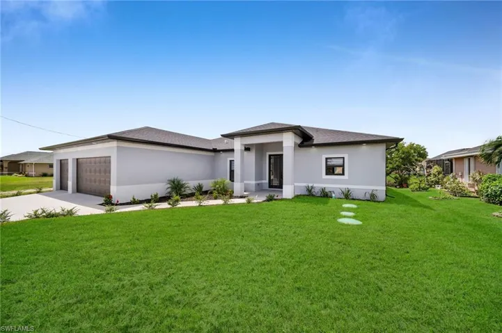 Prairie-style house with a garage and a front lawn