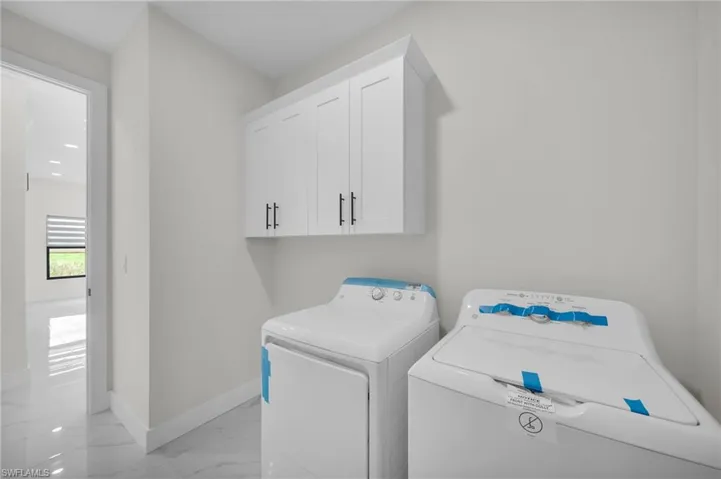 Laundry room with cabinets and independent washer and dryer