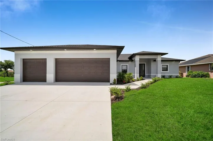 Prairie-style home with a garage and a front yard