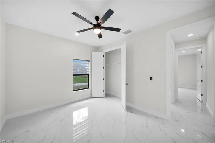 Unfurnished bedroom featuring a closet and ceiling fan