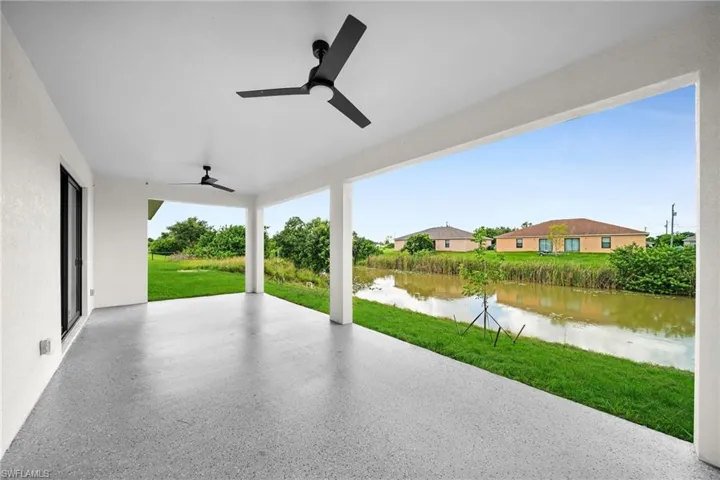 View of patio featuring a water view and ceiling fan