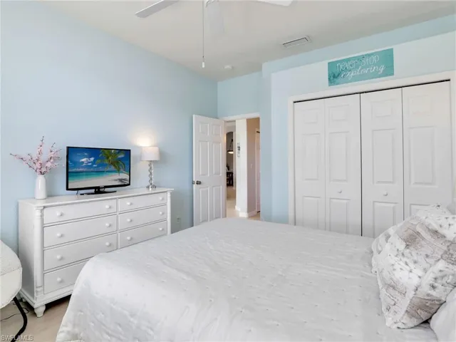 Bedroom with a closet, a ceiling fan, and light wood-style floors