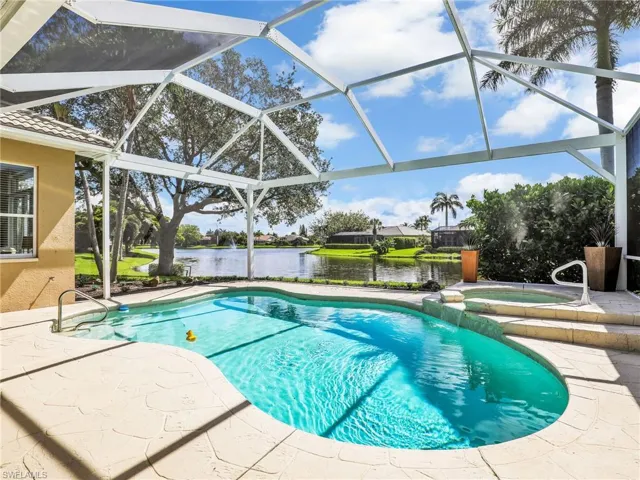 View of pool with a patio, a water view, and a lanai
