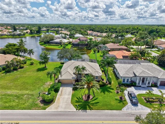 Aerial view of residential area featuring a nearby body of water