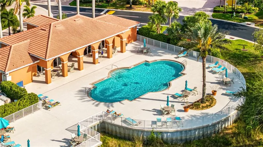 Community pool with fence and a patio area