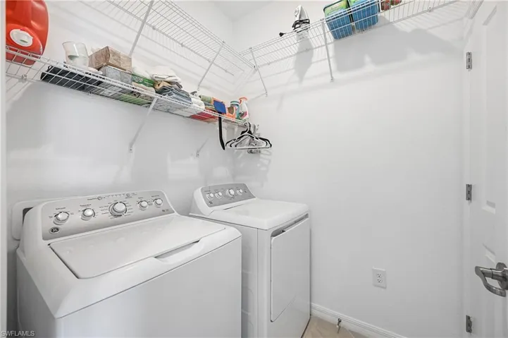 Laundry area featuring baseboards and washer and dryer