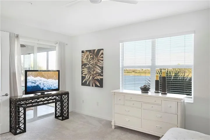 Bedroom featuring light carpet and a ceiling fan