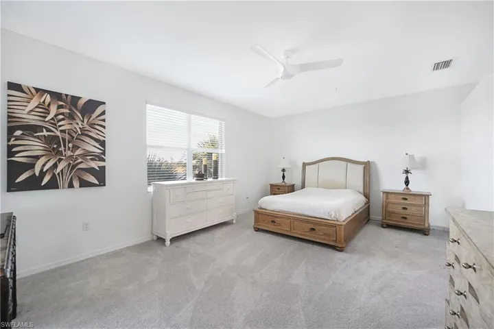 Bedroom with light carpet and ceiling fan