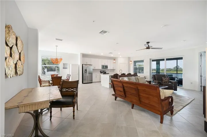 Living area featuring ceiling fan, light tile patterned floors, and recessed lighting