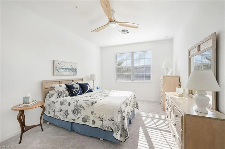 Bedroom with light carpet and ceiling fan