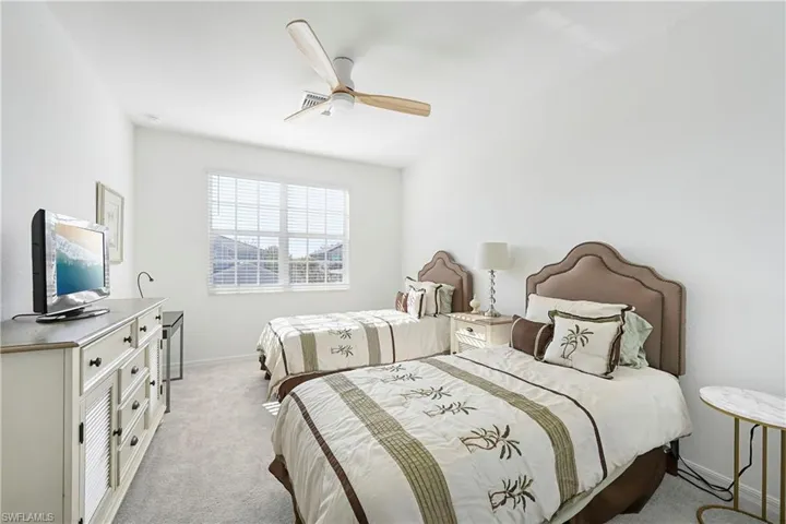 Bedroom featuring light colored carpet and ceiling fan
