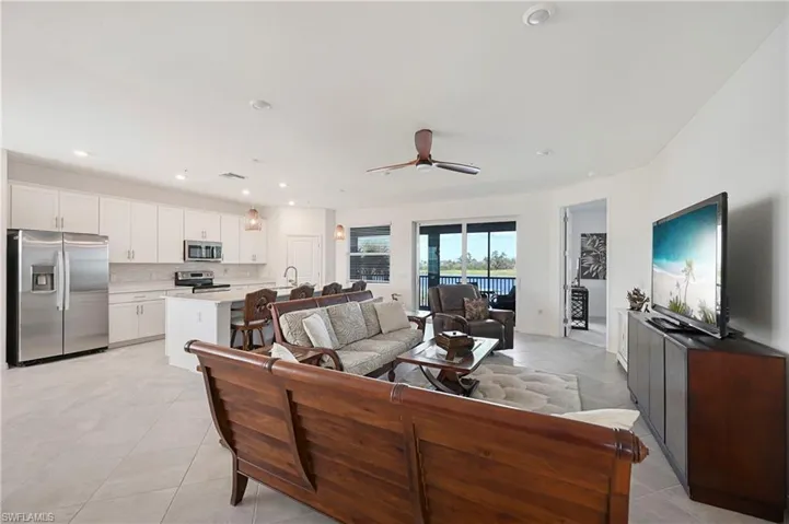 Living area with a ceiling fan and recessed lighting