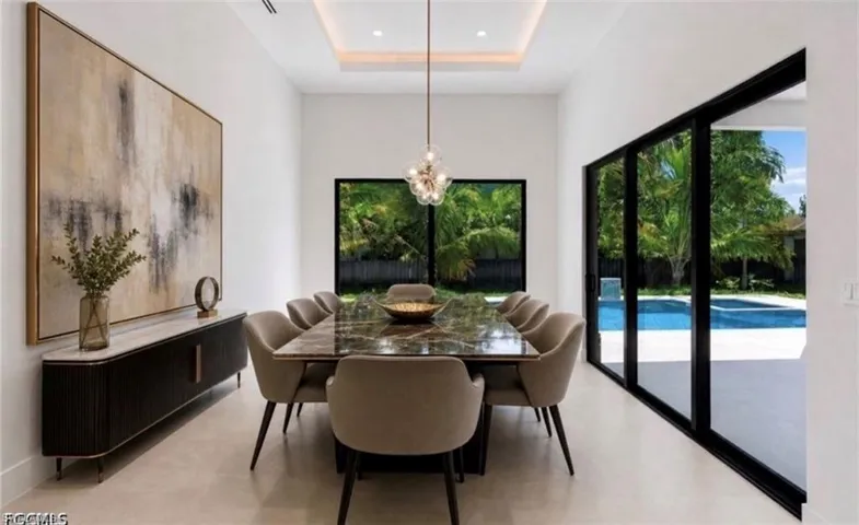 Dining area with a recessed ceiling and overhead light fixture