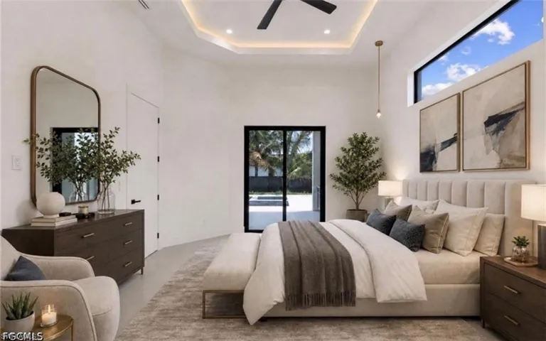 High ceilings featuring a tray ceiling with recessed lighting and a ceiling fan