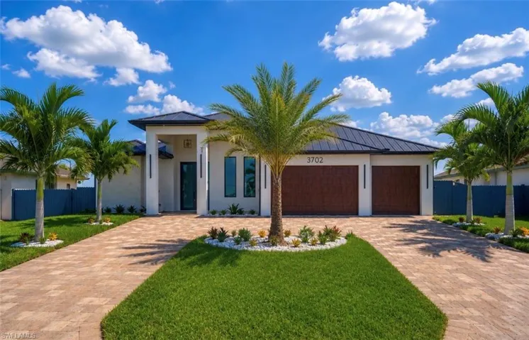 Contemporary stucco exterior with a dark metal roof