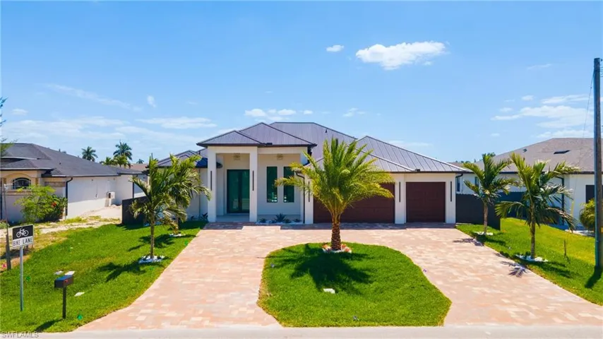 The property features a contemporary architectural style with a dark-colored roof and light-colored exterior walls
