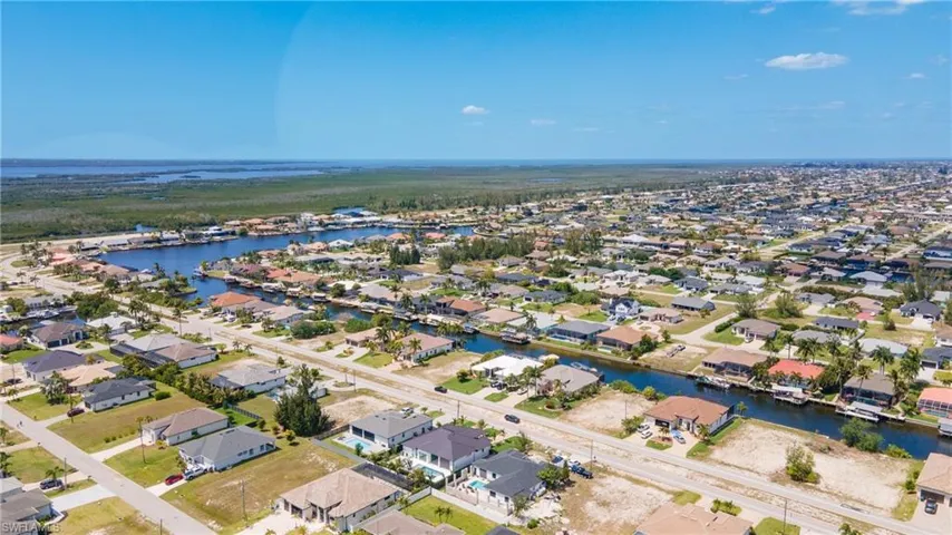 Aerial view of the neighborhood showcasing canal access and surrounding bodies of water