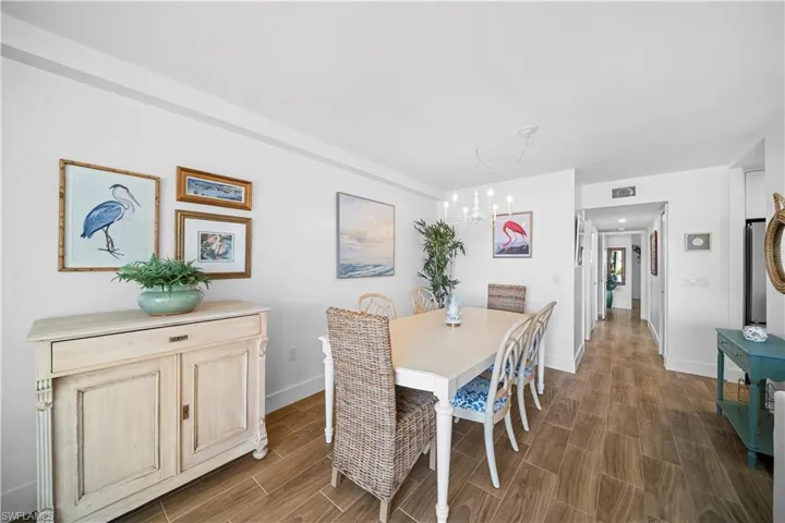 Dining space featuring wood finish floors and a chandelier
