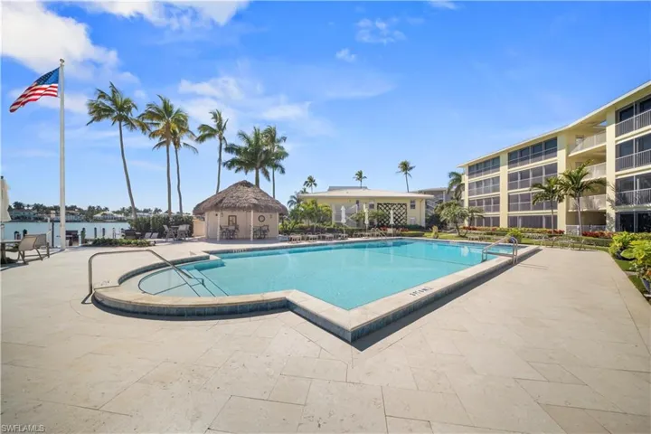 Community pool with a patio
