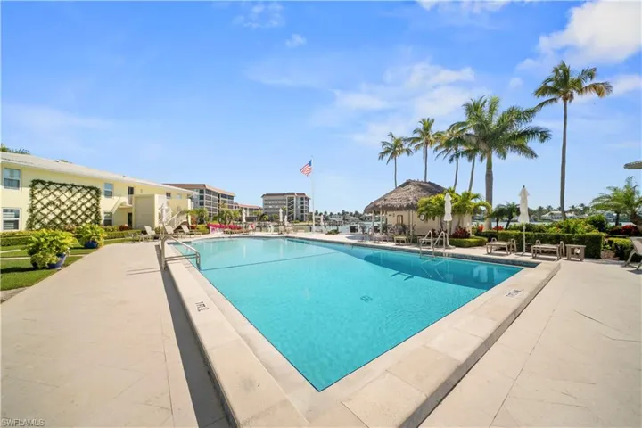 Community pool with a patio