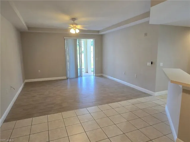 Unfurnished room with ceiling fan and light tile patterned flooring