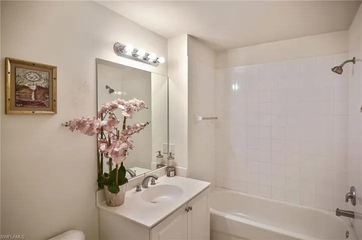 Bathroom featuring vanity and tiled shower / bath