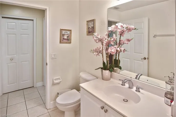 Bathroom featuring tile patterned floors, vanity, and toilet