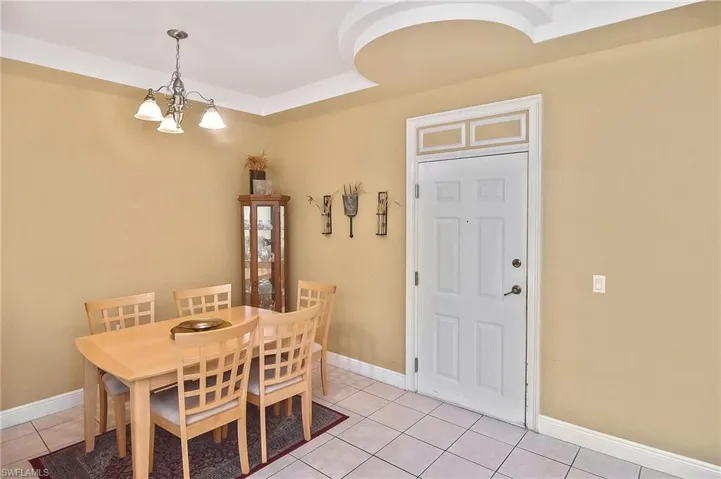Tiled dining room with a notable chandelier