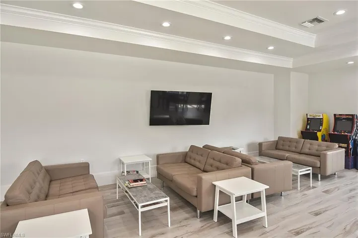 Living room featuring light wood-type flooring and crown molding