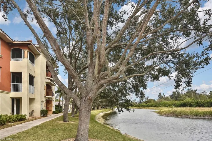 View of property's community with a yard and a water view