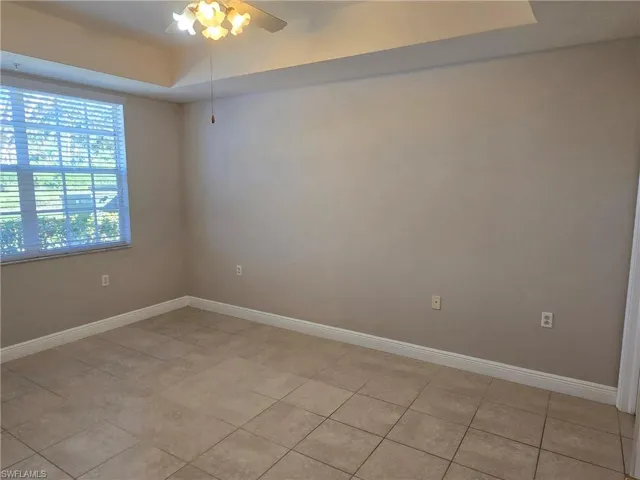 Unfurnished room featuring ceiling fan and light tile patterned floors