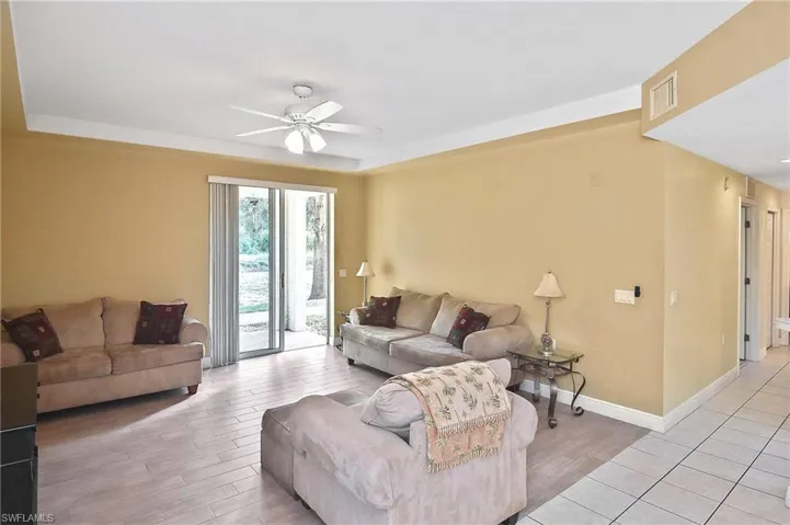 Living room with light wood-type flooring and ceiling fan
