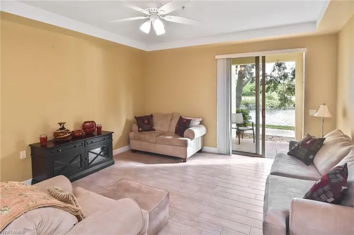 Living room with ceiling fan and light wood-type flooring