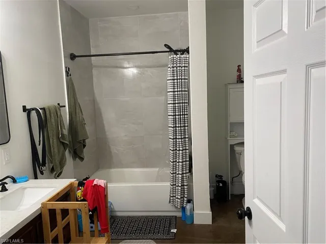 Full bath featuring shower / bath combo and vanity