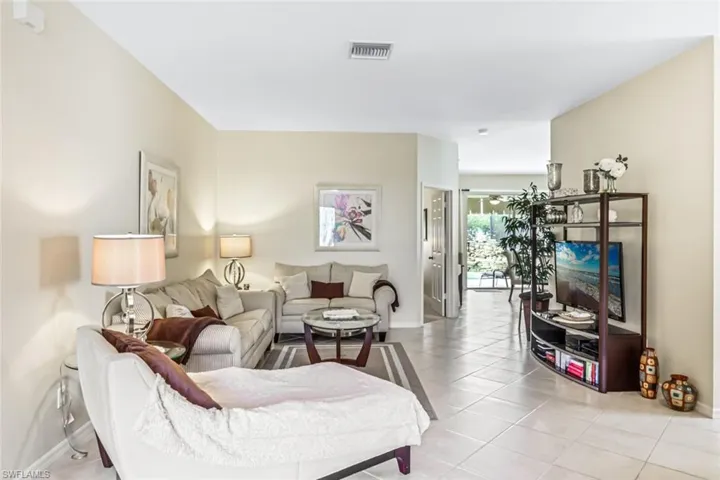 Living room with light tile patterned flooring