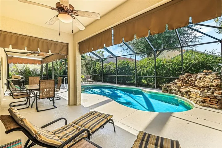 View of pool featuring a lanai, a patio area, and ceiling fan