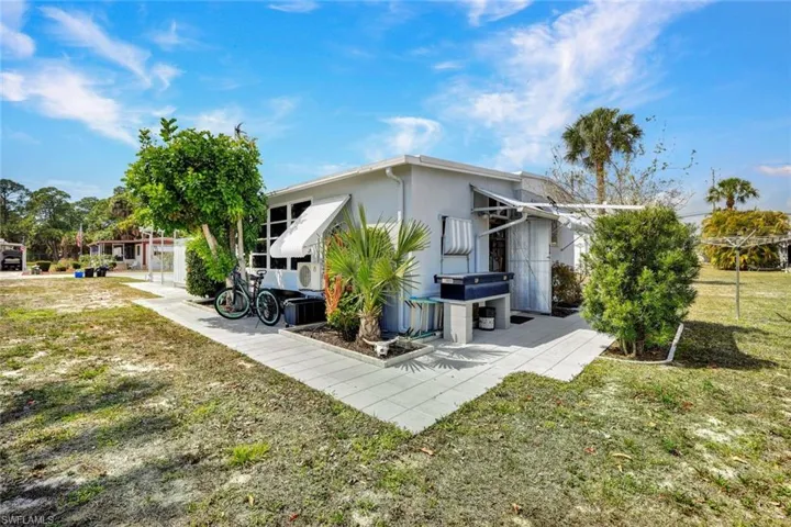 Back of property featuring a yard