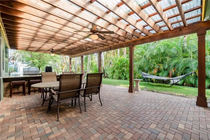 Outdoor Dining area overlooking backyard and outdoor kitchen