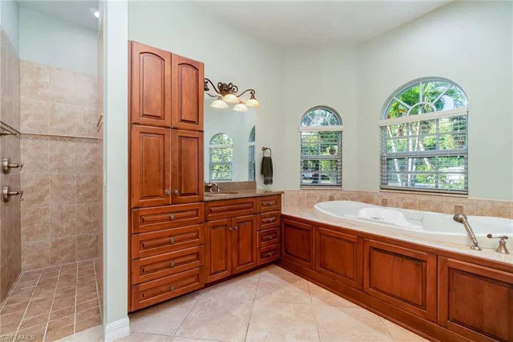 Primary Bath with walk in shower and jetted tub. Look at all this storage!