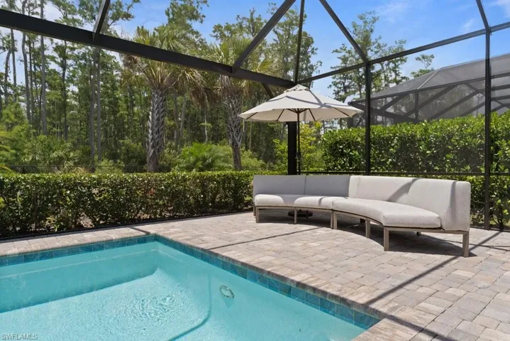 Outdoor pool featuring a patio, a lanai, and outdoor lounge area