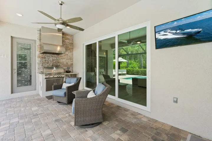 View of patio / terrace with a ceiling fan and grilling area