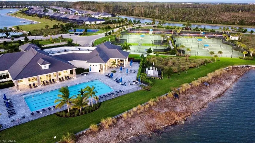 Aerial view of a pool area and a nearby body of water