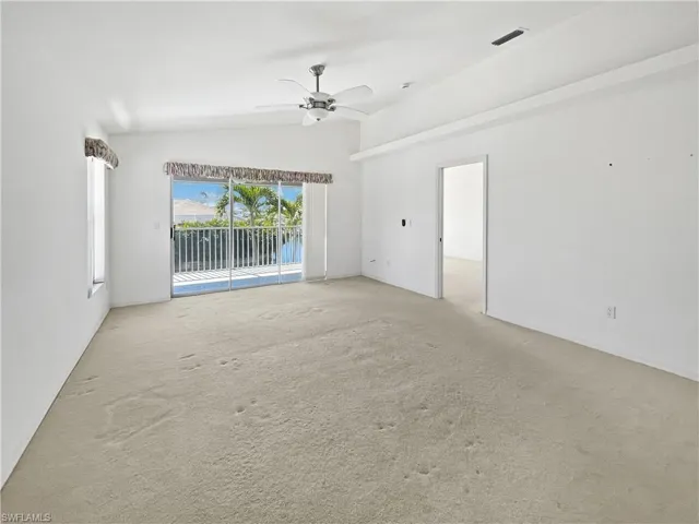 Living/Family room featuring carpet floors, vaulted ceiling, and ceiling fan