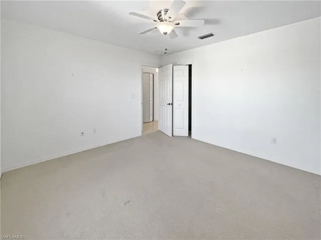 Guest bedroom with carpet flooring and ceiling fan