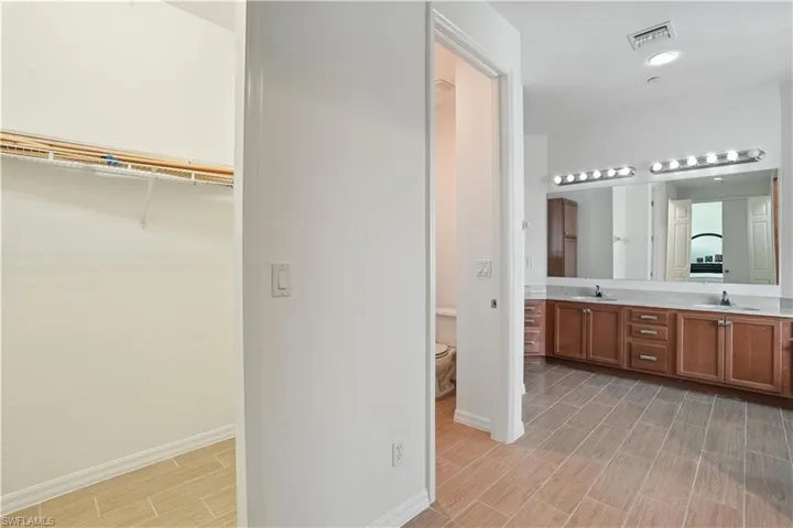 Spacious bathroom featuring an extended double vanity with undermount sinks and a large mirror